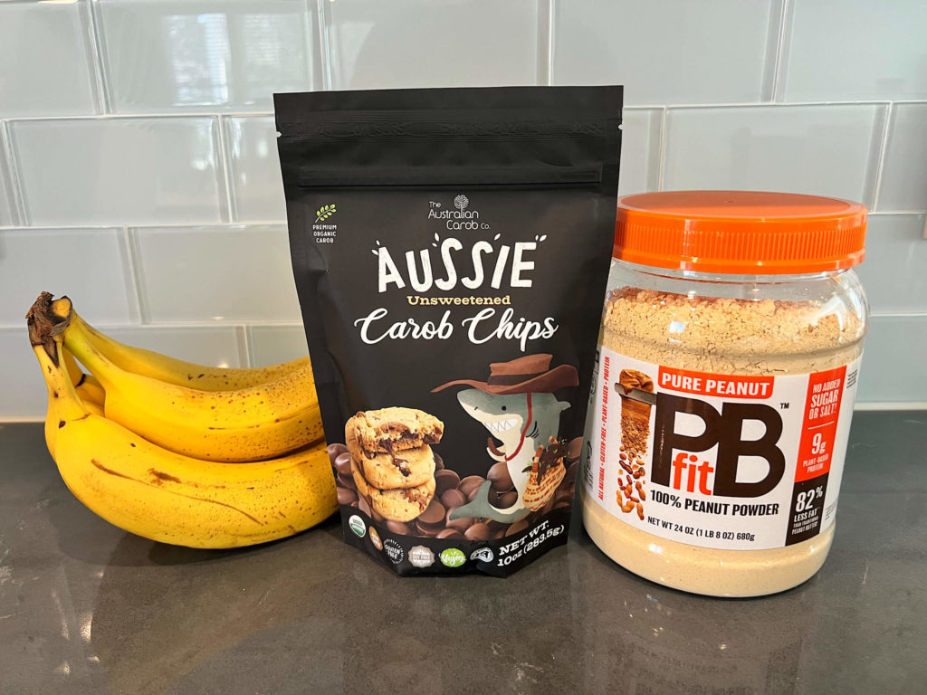 Ingredients for a West Paw Toppl recipe:  bananas, a package of unsweetened carob chips and peanut butter powder.